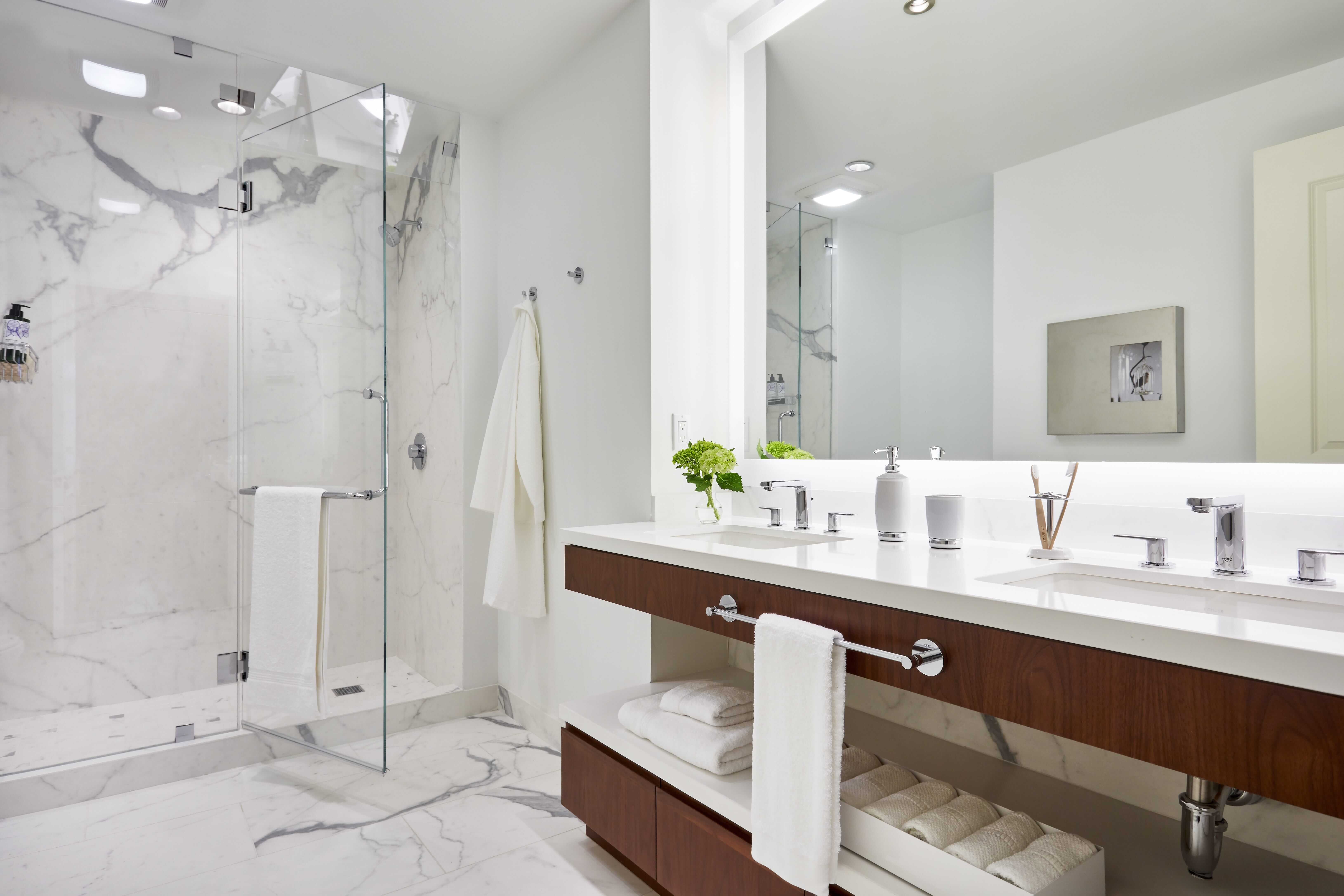 contemporary bathroom , luxury condo living , marble looking porcelain slab , interior designer near me , apartment design , interior decorator in DC