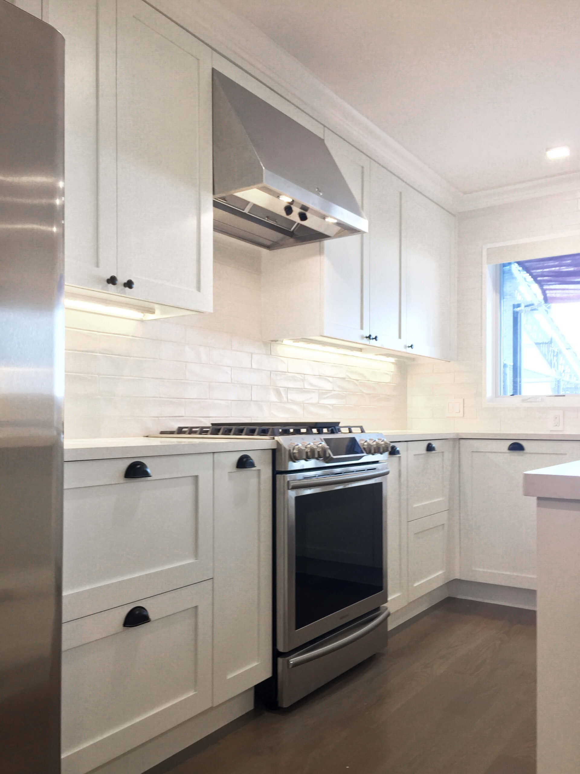 white quartz countertop, white shaker cabinetry, contemporary kitchen , white backsplash tile ,full house renovation , full house renovation , home renovation