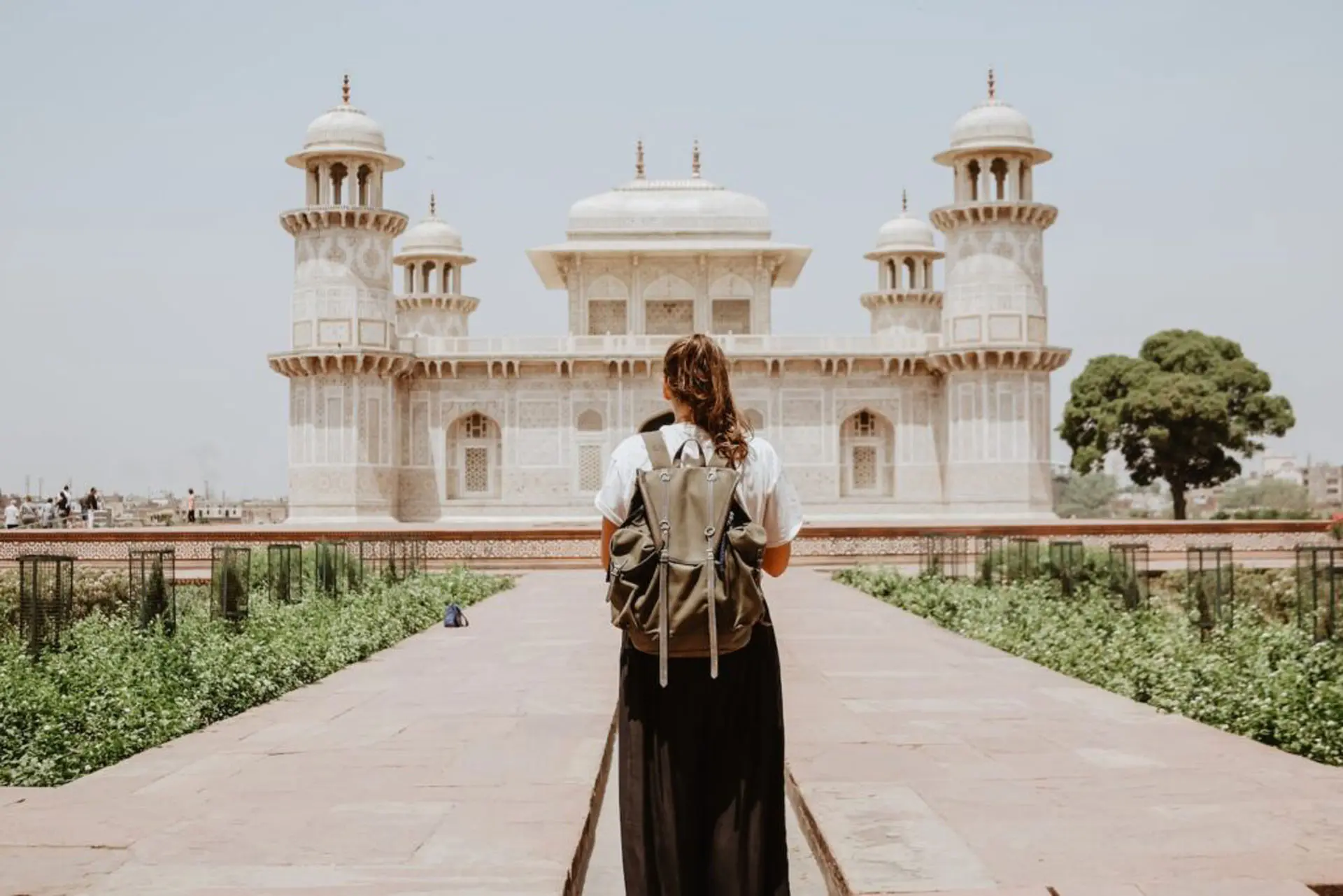 woman near beige painted building , travel decor,