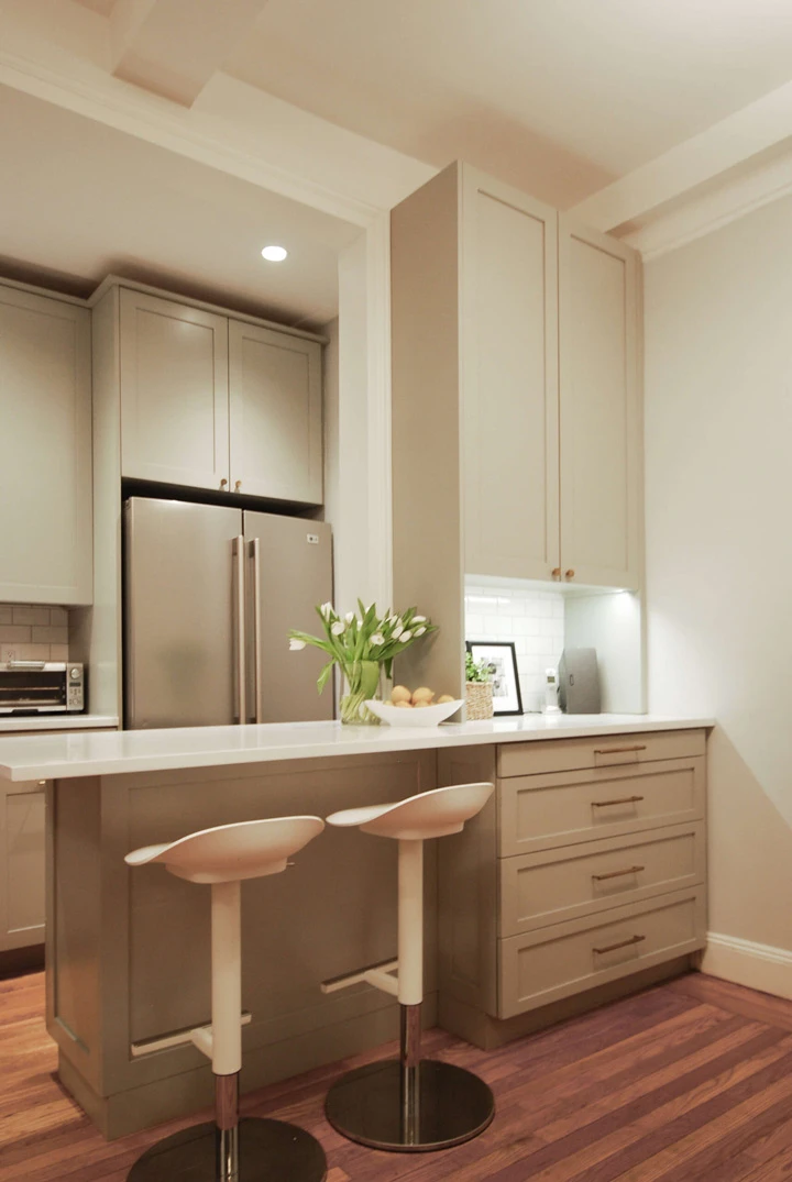 white quartz countertop, colored shaker cabinetry, transitional kitchen , white subway backsplash tile